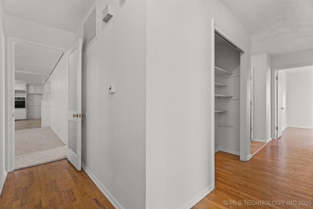 corridor with wood-type flooring