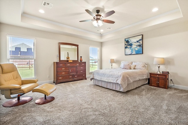 bedroom with ceiling fan, a raised ceiling, carpet floors, and ornamental molding