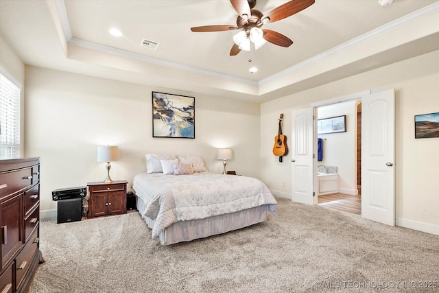 bedroom featuring a tray ceiling, ceiling fan, light colored carpet, and ornamental molding