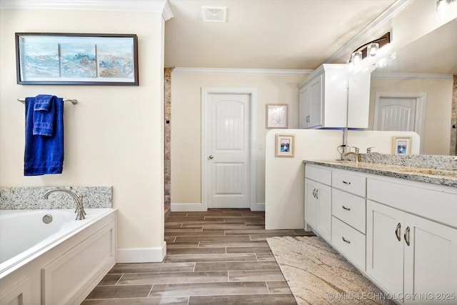 bathroom with a tub, hardwood / wood-style floors, vanity, and ornamental molding