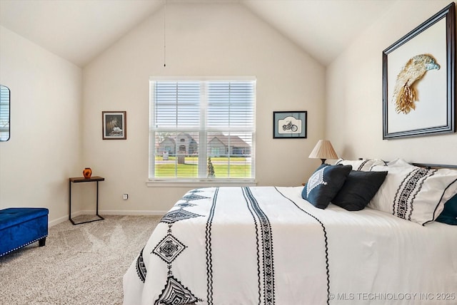 bedroom with carpet floors and lofted ceiling