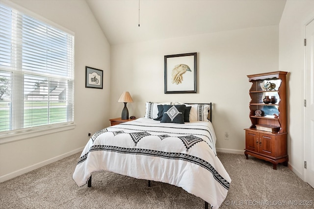 bedroom featuring light carpet, vaulted ceiling, and multiple windows