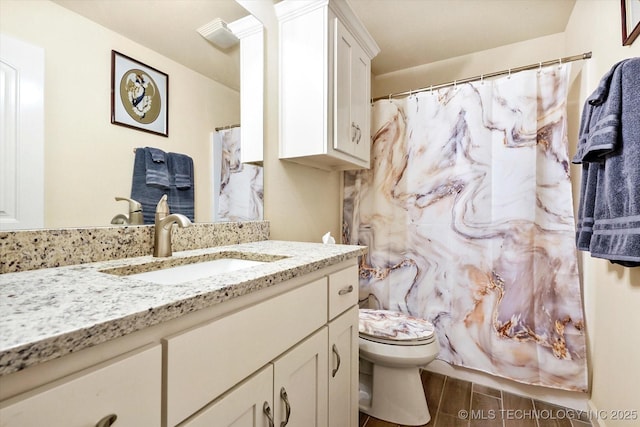 bathroom featuring vanity and toilet