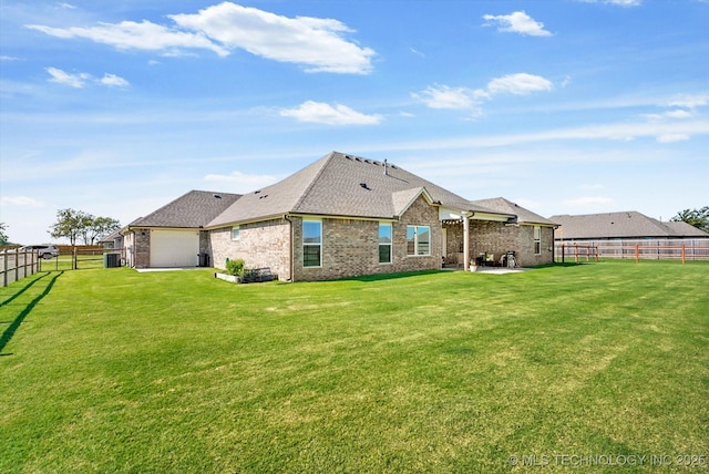 rear view of house featuring a yard