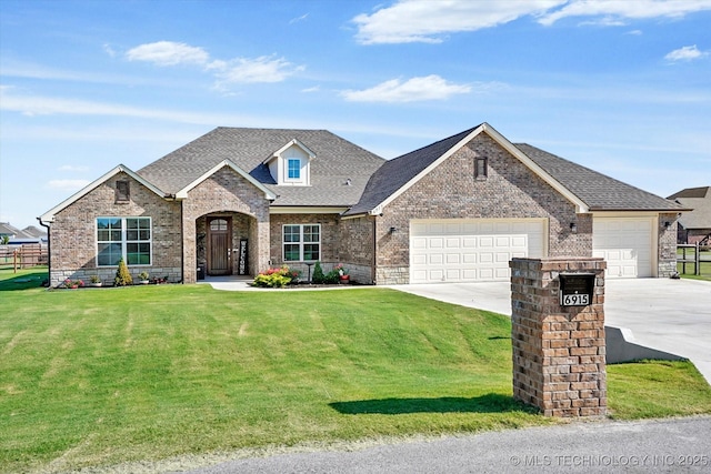 view of front of property featuring a garage and a front yard