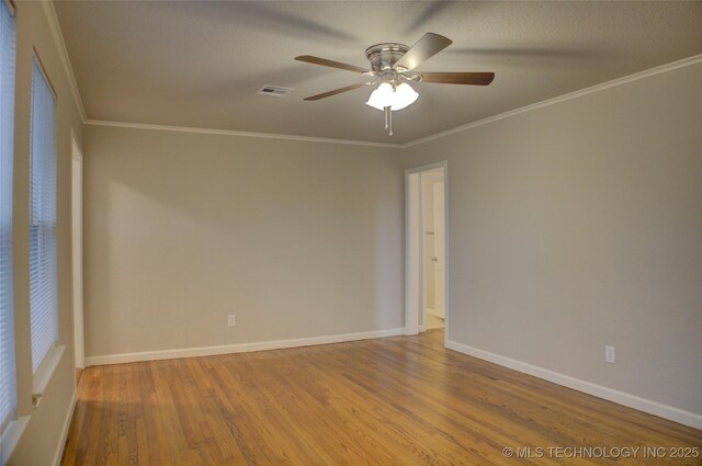 empty room with light wood-type flooring, ceiling fan, and ornamental molding