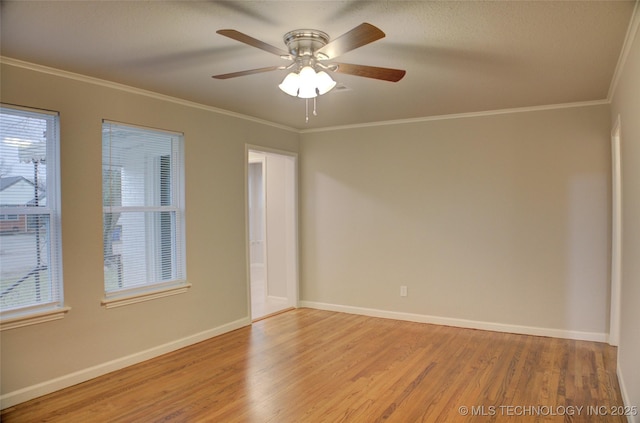 spare room featuring light hardwood / wood-style flooring, ceiling fan, and crown molding