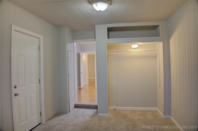 hallway with light carpet and ornamental molding