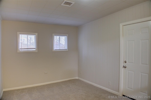 unfurnished room featuring ornamental molding and light carpet