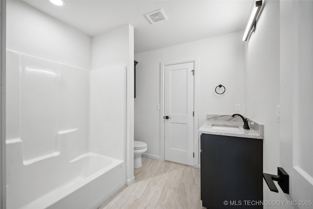 full bathroom with vanity, shower / bathtub combination, and toilet