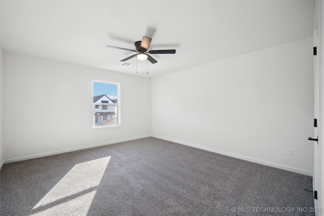 unfurnished room with ceiling fan and dark colored carpet