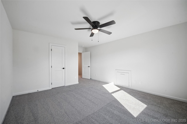 carpeted spare room featuring ceiling fan