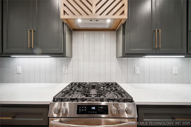 kitchen with gas range, decorative backsplash, and custom range hood