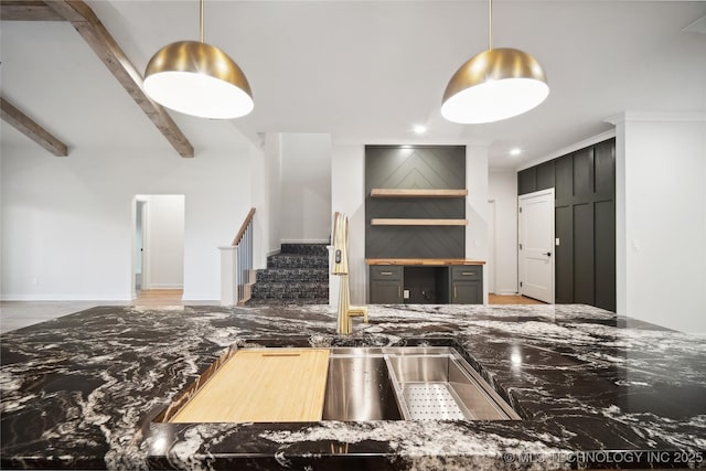 kitchen featuring beamed ceiling and kitchen peninsula