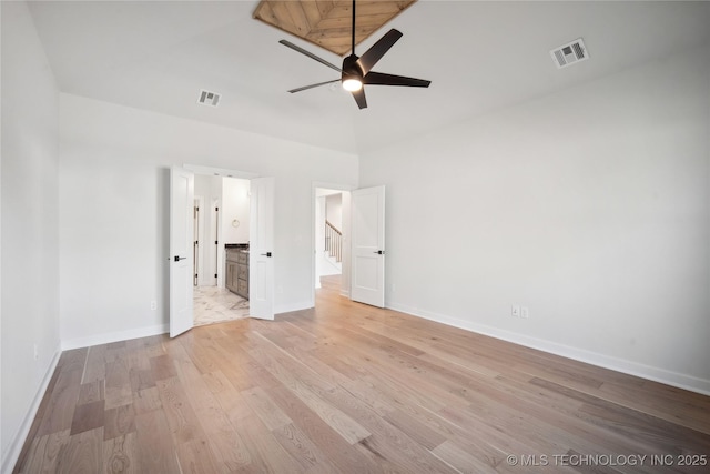 unfurnished bedroom featuring ceiling fan, light hardwood / wood-style flooring, and high vaulted ceiling