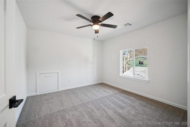 carpeted spare room with ceiling fan