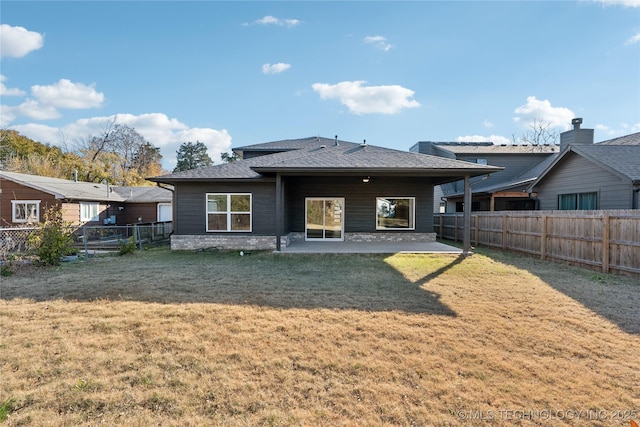 rear view of house featuring a yard and a patio area