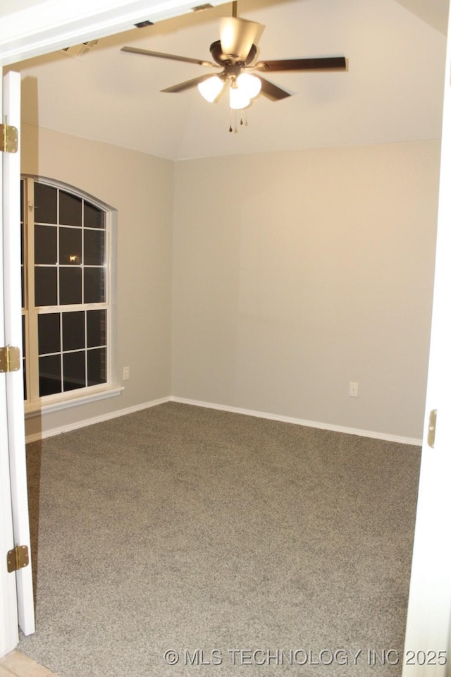 empty room with ceiling fan and carpet floors