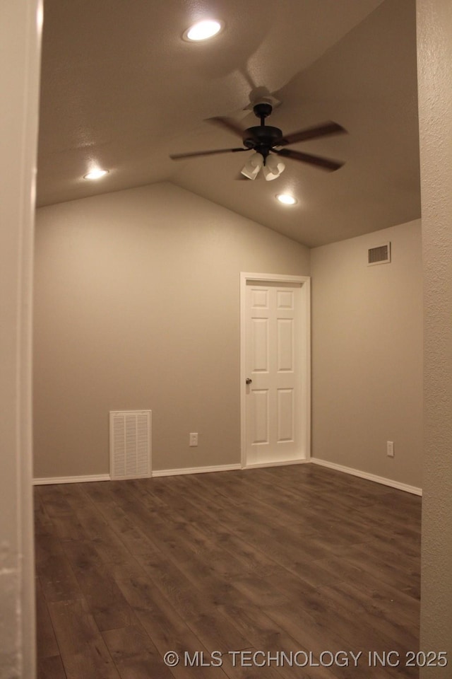 empty room with dark wood-type flooring, ceiling fan, and lofted ceiling