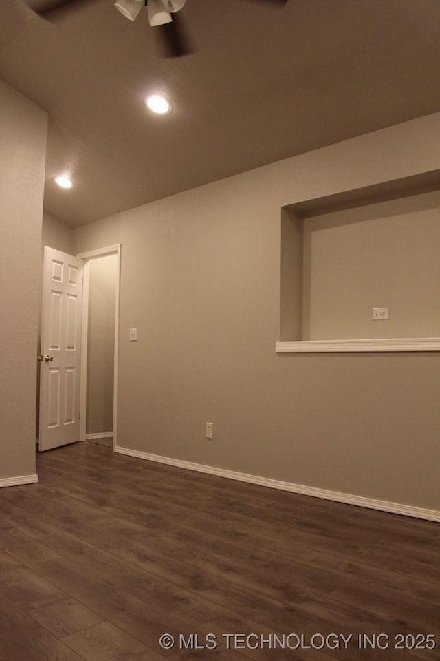 empty room featuring ceiling fan and dark hardwood / wood-style flooring