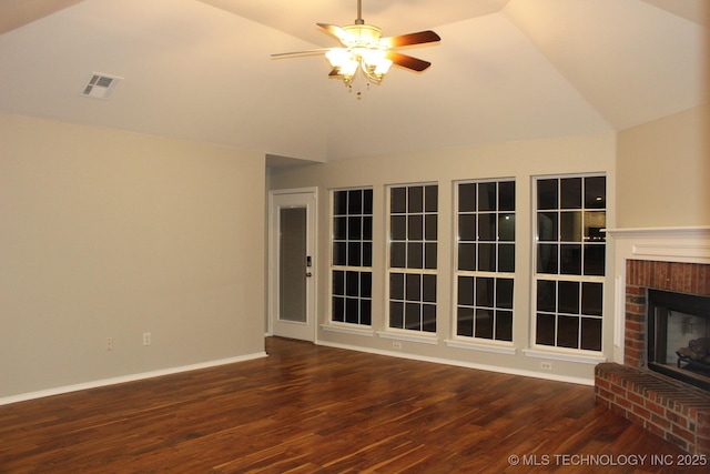 unfurnished living room featuring ceiling fan, dark hardwood / wood-style floors, lofted ceiling, and a brick fireplace