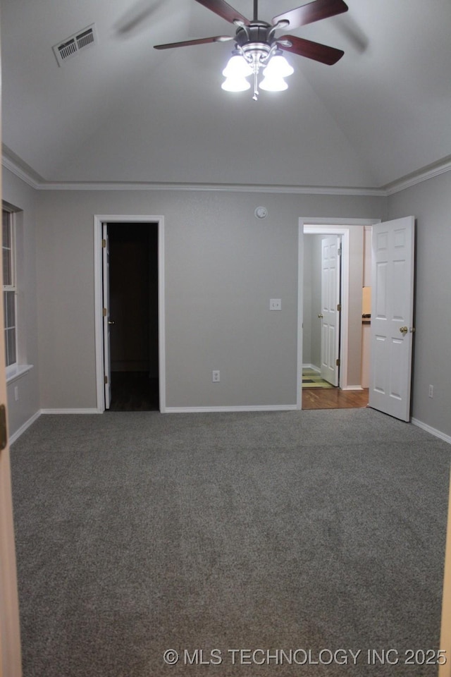 carpeted empty room with ceiling fan, lofted ceiling, and ornamental molding