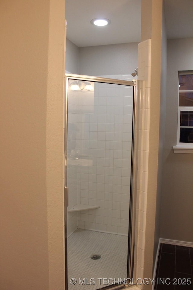 bathroom featuring tile patterned floors and an enclosed shower