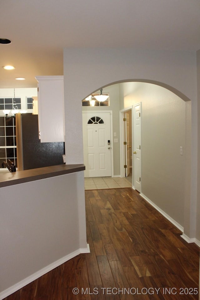 corridor with dark hardwood / wood-style flooring