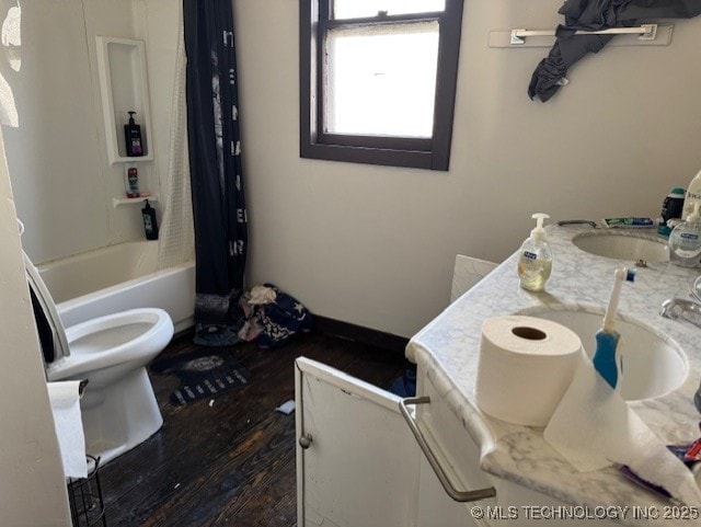 full bathroom featuring hardwood / wood-style floors, vanity, shower / bath combination with curtain, and toilet