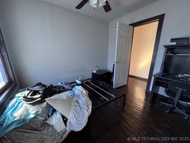 bedroom featuring ceiling fan and dark wood-type flooring