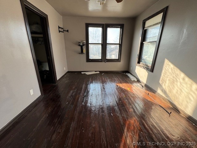 spare room featuring ceiling fan and dark hardwood / wood-style floors