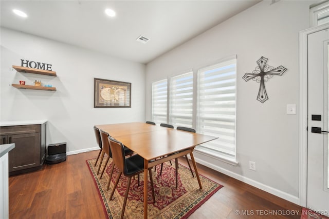 dining area with dark hardwood / wood-style flooring