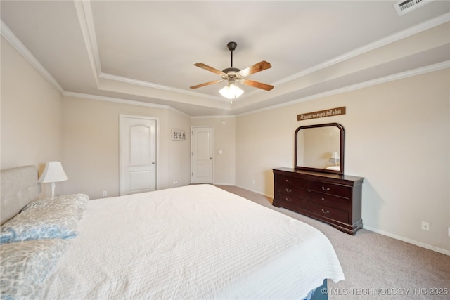 carpeted bedroom with a raised ceiling, ceiling fan, and crown molding