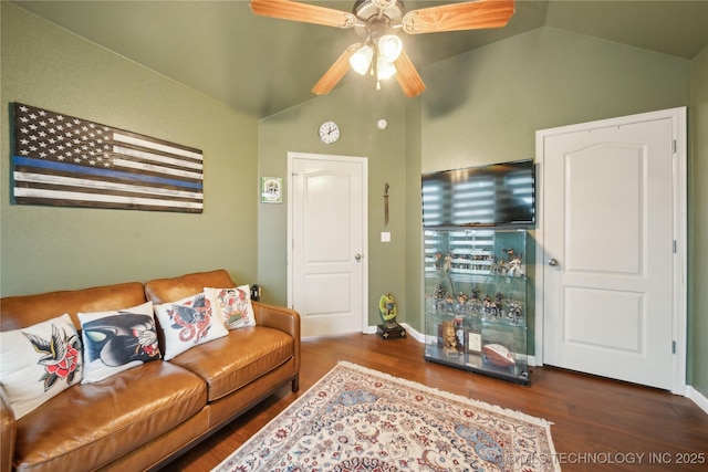 living room featuring dark hardwood / wood-style flooring, vaulted ceiling, and ceiling fan