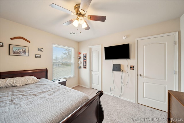 bedroom featuring ceiling fan and light carpet