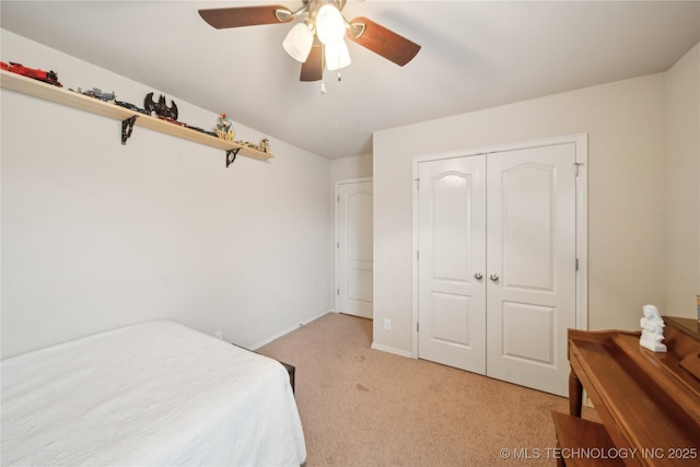 bedroom featuring light carpet, a closet, and ceiling fan