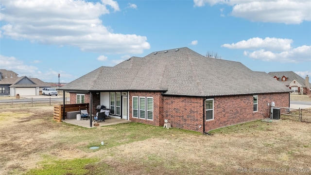 back of house featuring a yard, a patio, and central AC unit