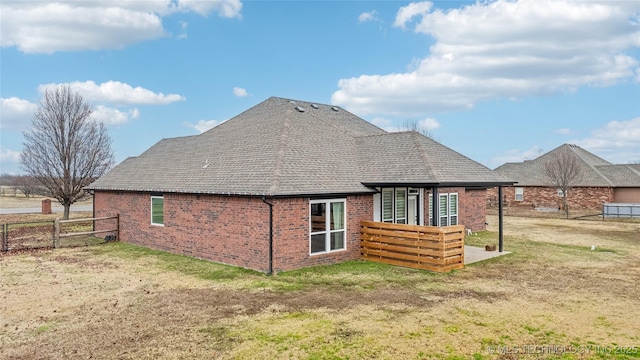 rear view of property featuring a yard