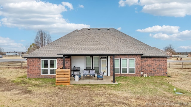 back of house with a patio area and a lawn