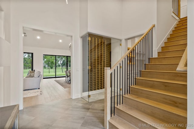 foyer featuring a high ceiling and concrete floors