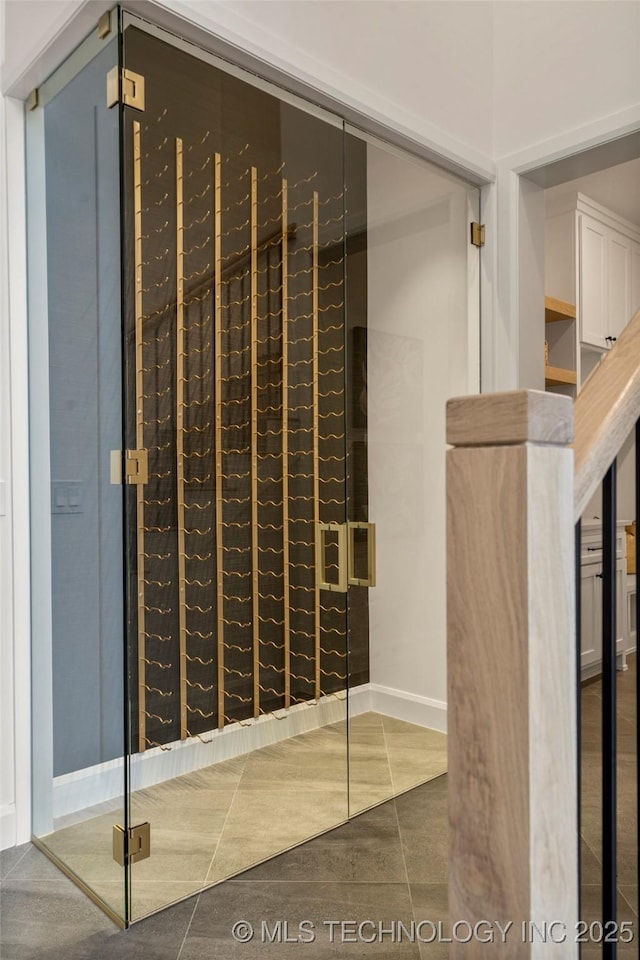 wine room with dark tile patterned floors