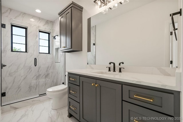 bathroom featuring vanity, toilet, and a shower with door