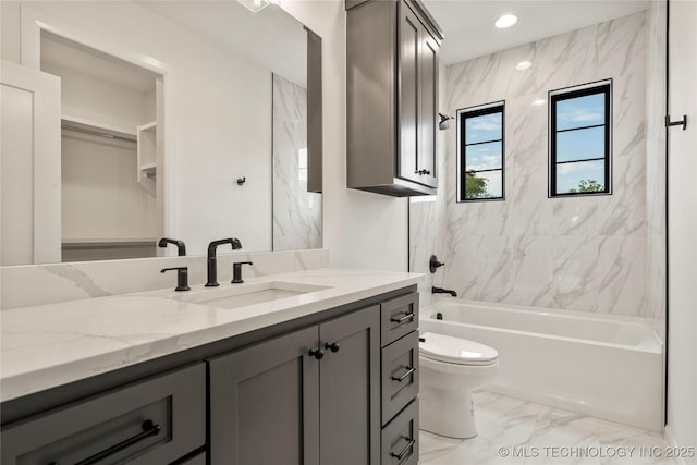 full bathroom with vanity, toilet, and tiled shower / bath