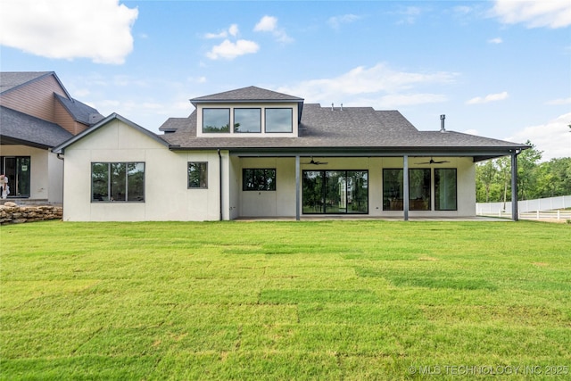 back of house with a yard and ceiling fan