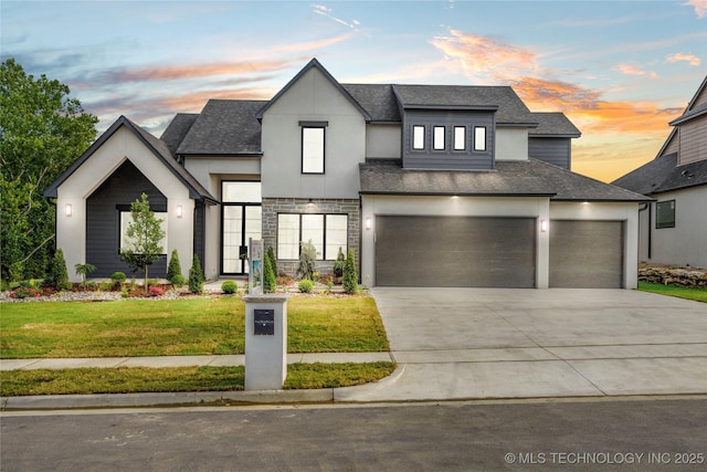 view of front of home with a lawn and a garage