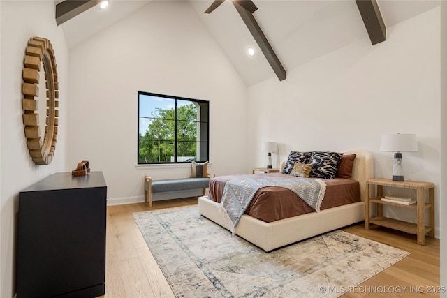 bedroom with wood-type flooring, high vaulted ceiling, ceiling fan, and beam ceiling