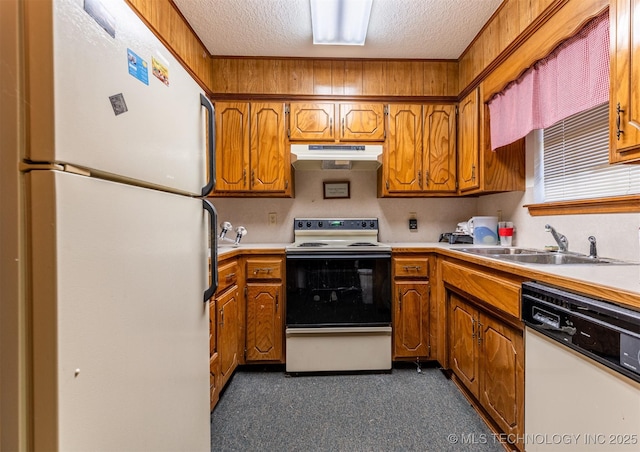 kitchen featuring a textured ceiling, sink, and white appliances