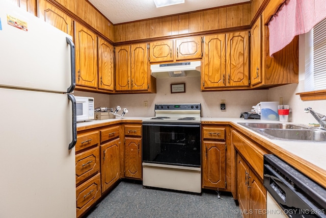 kitchen featuring a textured ceiling, sink, and white appliances