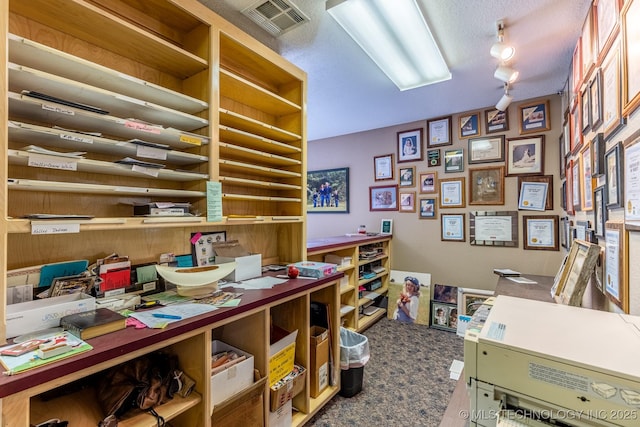 office featuring a textured ceiling and rail lighting