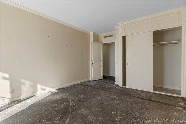 unfurnished bedroom with ornamental molding and a closet